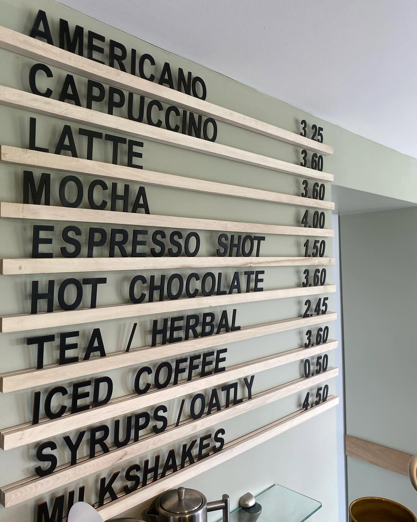 Wooden letter board menu on the café wall